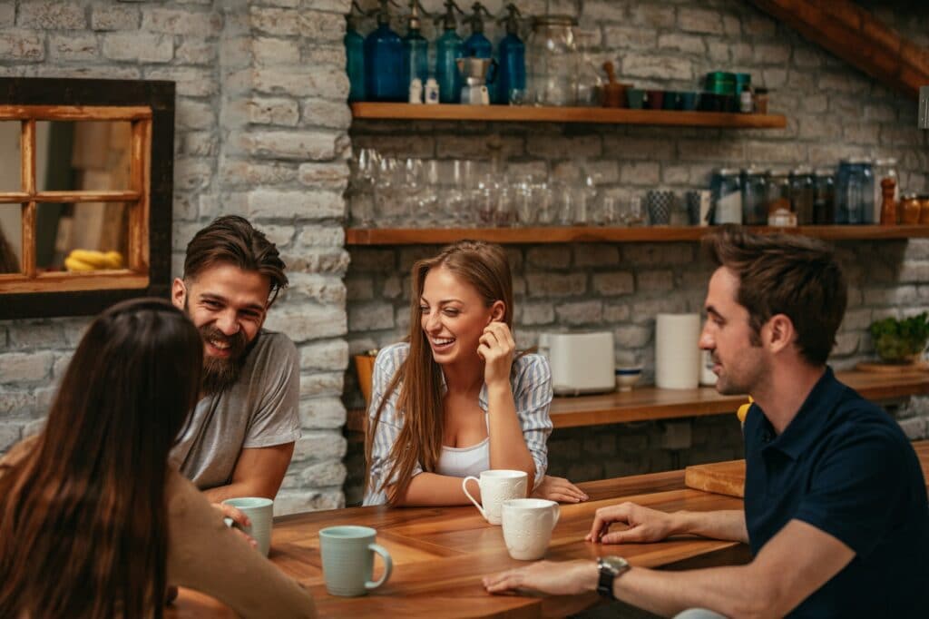 jeunes colocataires rient atour d'une table