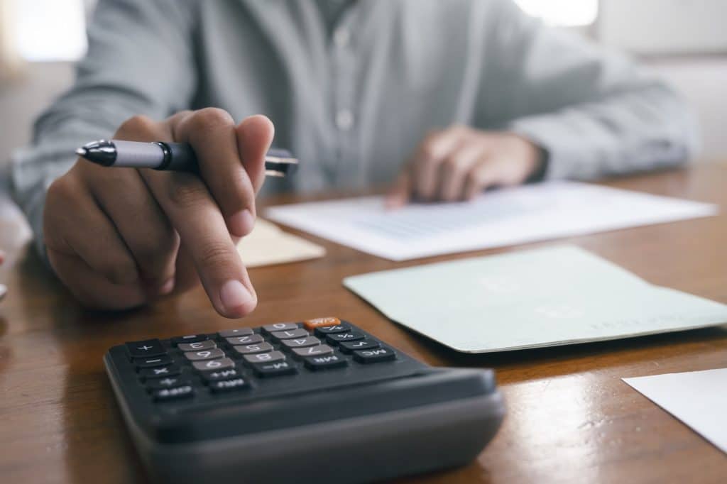 Closeup accountant using calculator.