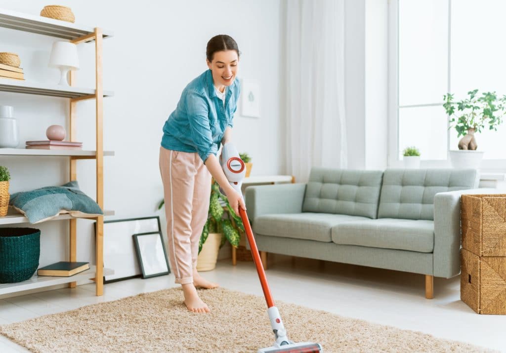 woman vacuuming the room
