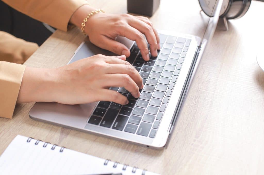 Women Worker Typing on Laptop